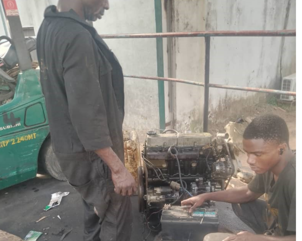 Technicians performing forklift engine reinstallation and electrical system repair in Ogun and Lagos