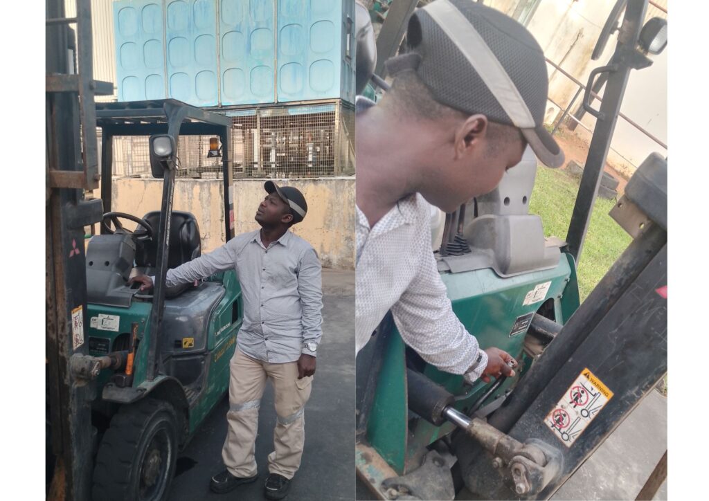 Forklift technician carrying out safety inspection and maintenance checks on an industrial forklift in Lagos warehouse facility.